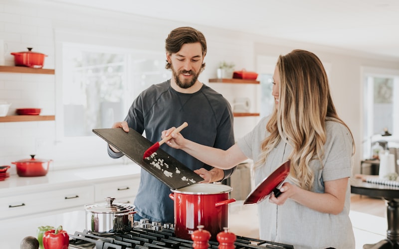 Beautifully remodeled high-end kitchen featuring modern custom kitchen cabinets, stone countertops, and a large stainless steel sink.